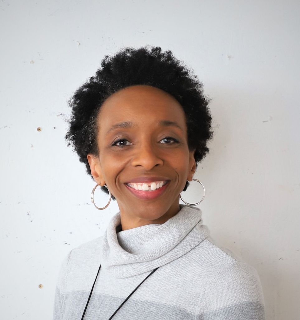 Black woman with natural hair with smile and open expression